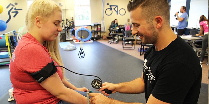 Hampton PT Guiding a patient through Blood Flow Restriction Therapy to help build strength