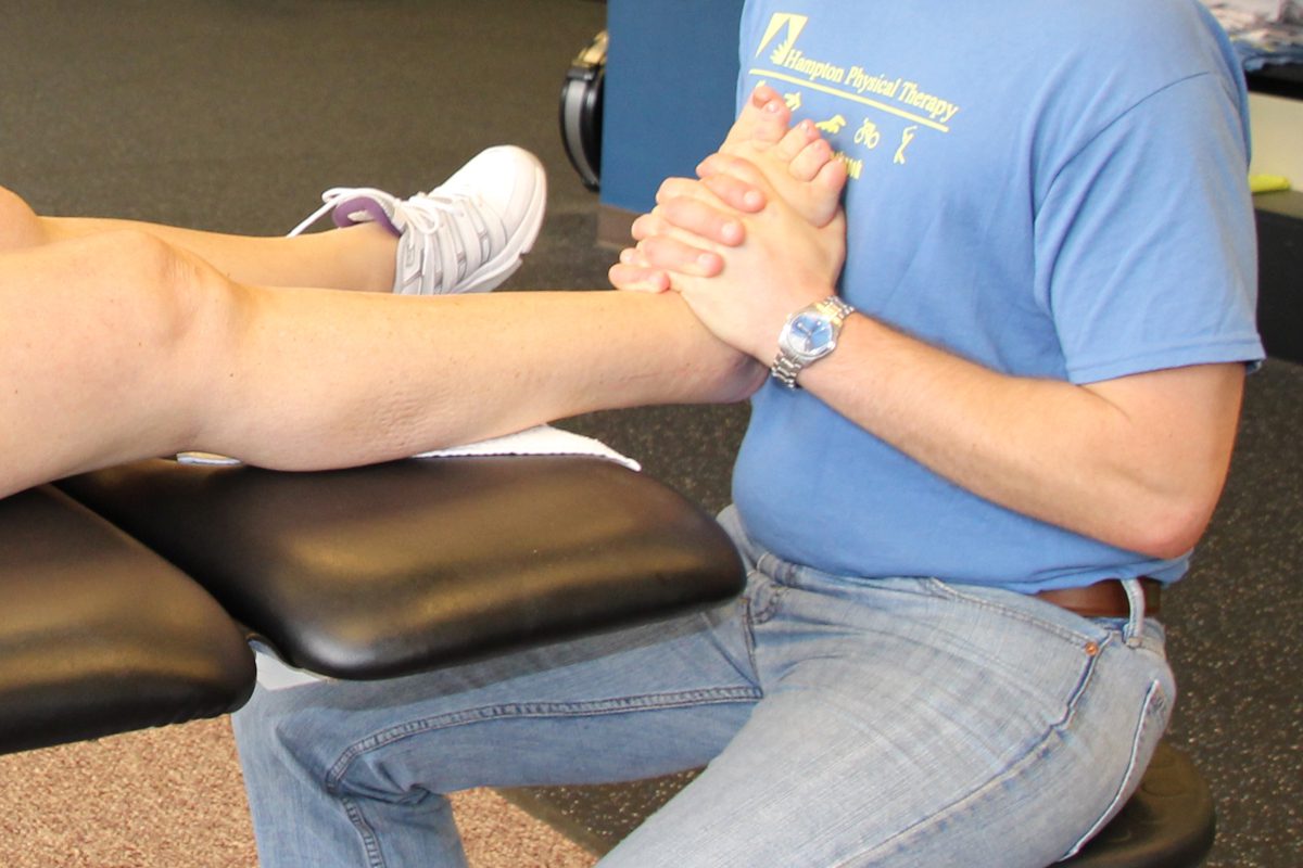 man massaging patient's foot